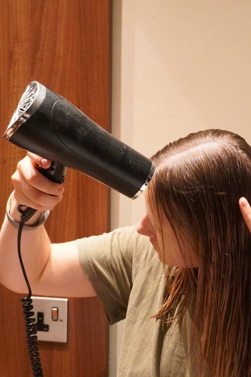 Helen using a hairdryer inside a Center Parcs lodge
