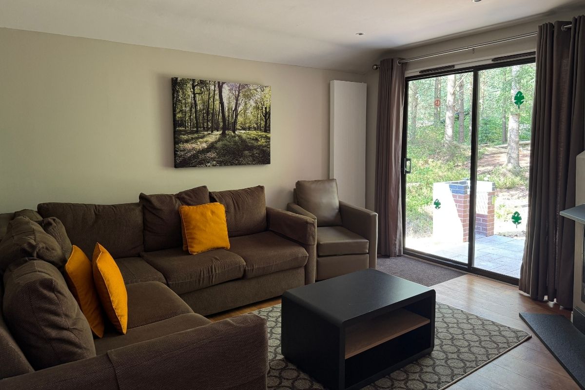 Living room and lounge area in a two-bedroom Woodland Lodge at Center Parcs Whinfell Forest