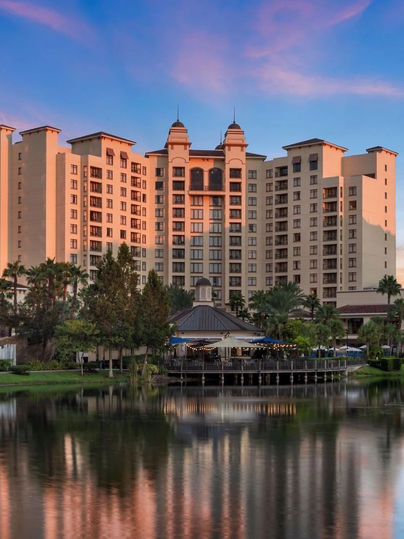 Wyndham Grand Bonnet Creek hotel exterior at dusk reflected in the lake