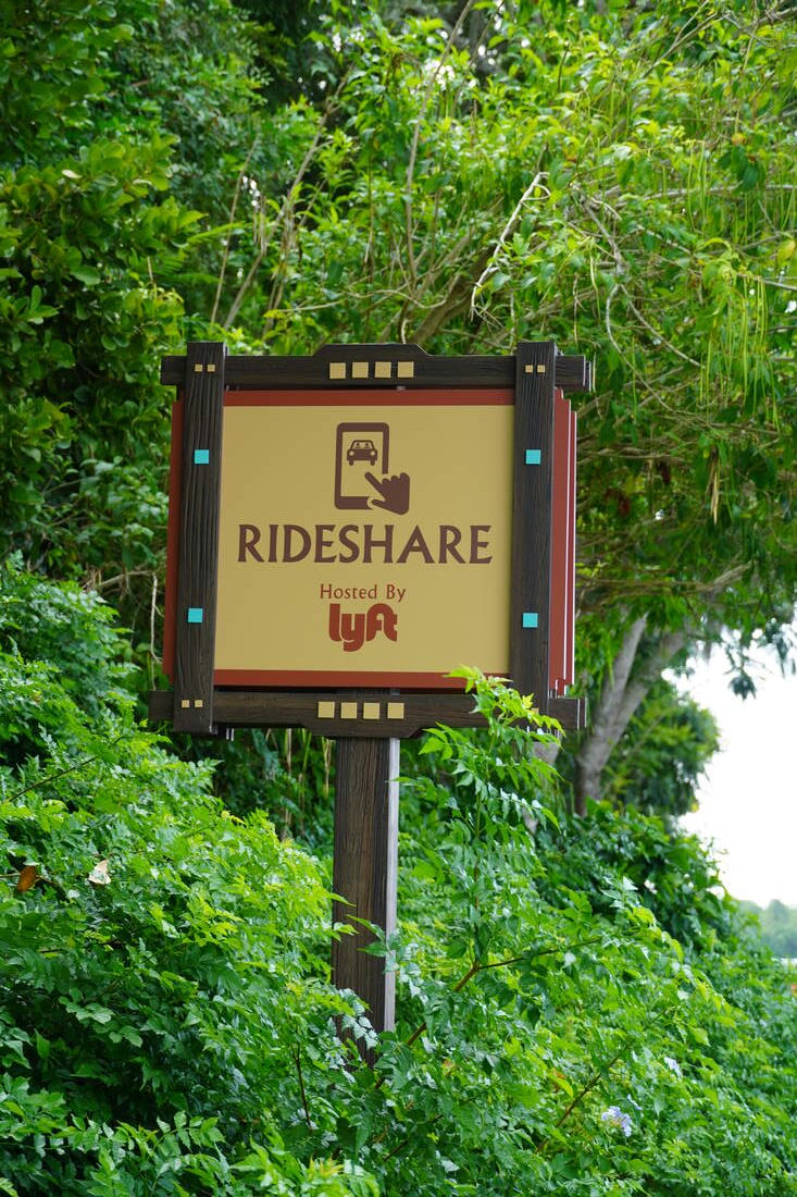 Sign at Animal Kingdom marking the rideshare pickup and drop-off zone for Lyft and Uber