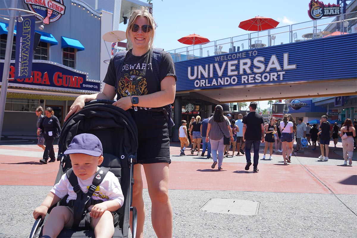 Helen and Oliver in a pushchair in front of the Universal Orlando entrance sign