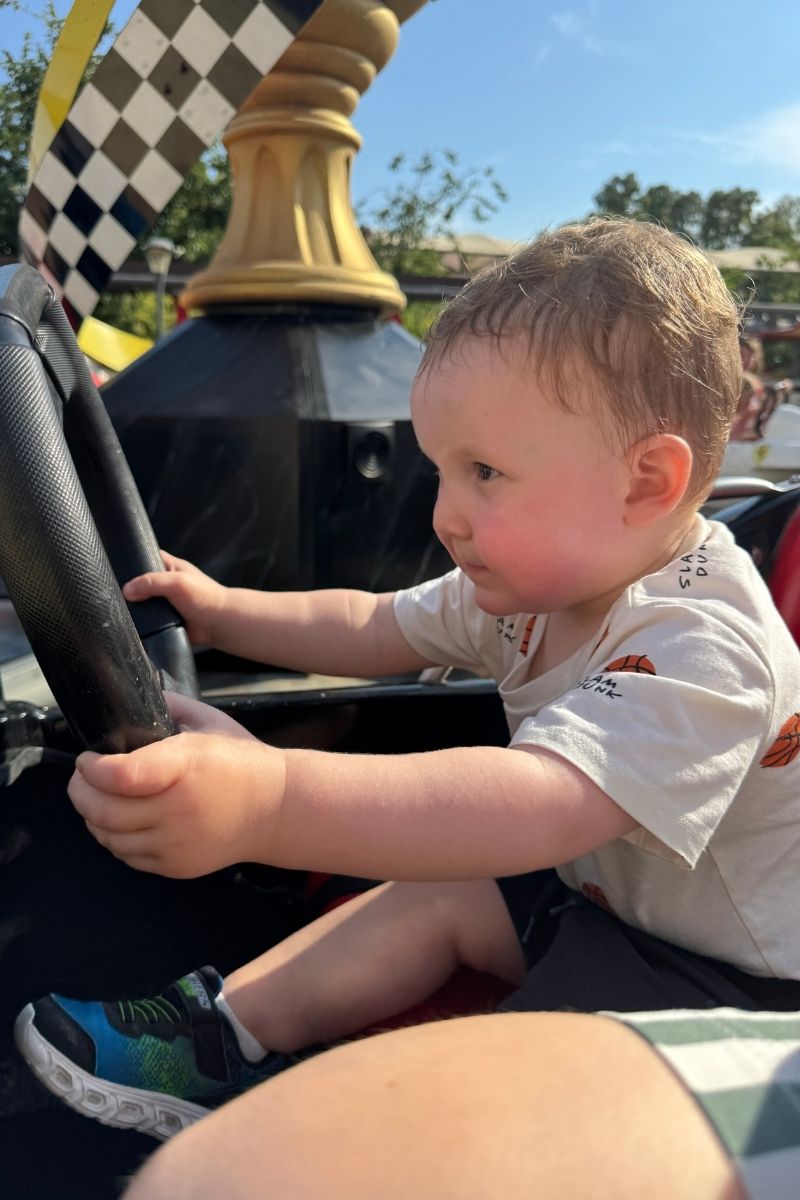 Patrick, aged almost two, driving a car on the Ferrari ride at Ferrari World in PortAventura, Salou